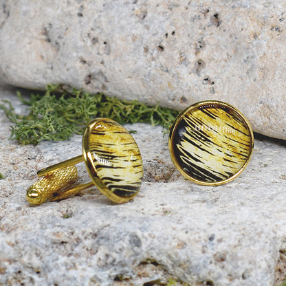 Gold cufflinks with black and gold cabochon