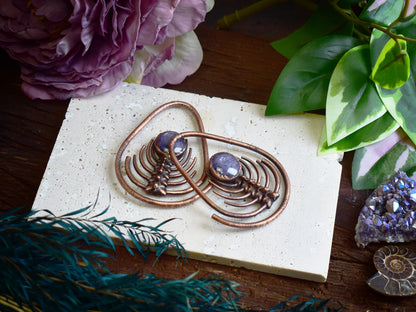 Detailed view of 3D printed snake vertebrae spine model electroformed in copper with star ruby centerpiece
