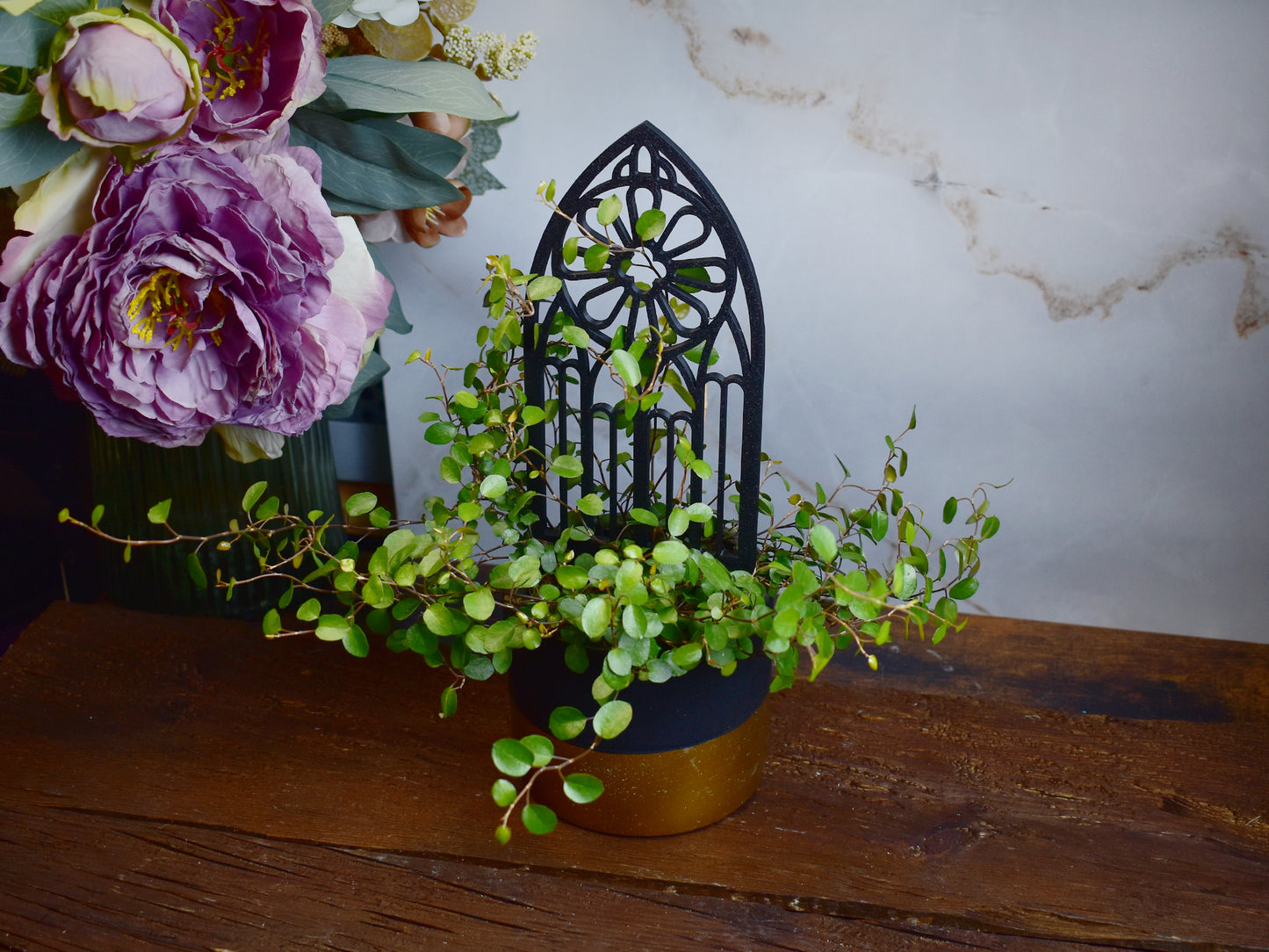 black gothic plant trellis shaped like medieval window