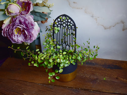 gothic arch plant support with detailed rose window pattern